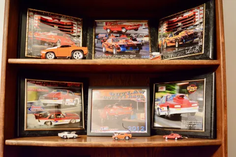 This display of racing photos and memorabilia shows some of the cars Archer and Son have raced over the years