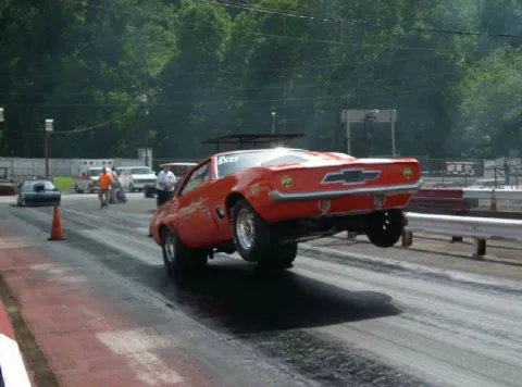 An Archer and Son car takes off with front wheels in the air.