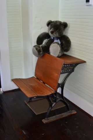 An antique school desk donated by Mr. and Mrs. Tom Orlan hearkens back to school days at Oak Grove.