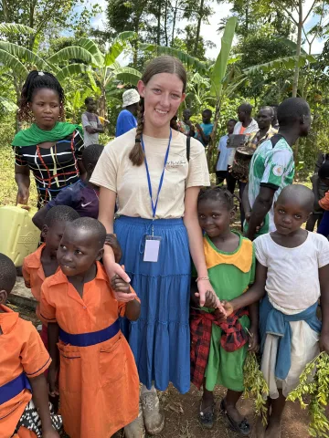 Melanie Hurst with new friends in Uganda.