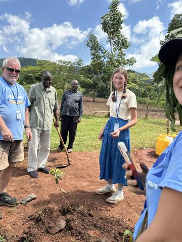 Photo by Desiree Hensley  Melanie Hurst and Mark Hensley with a tree planted in Buwasyeba Uganda.