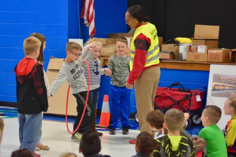 Safe Routes to School education coordinator Diana Benedict guides Luttrell Elementary students Dakota McClanahan, Kinnedy Loy, Zane Hill, Kinley Farmer and Skylar Conner through a game during traffic safety education.