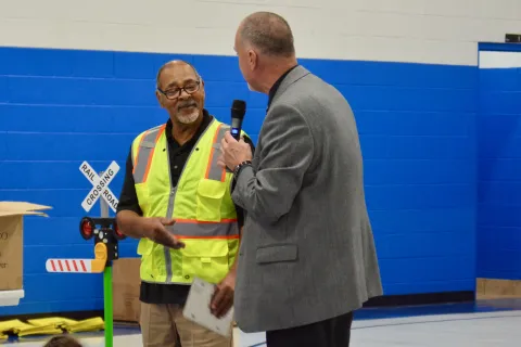 Safe Routes to School educator Mark Johnson receives a Vietnam Veterans license plate from Union County Mayor Mike Williams.