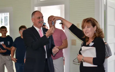 Union County Mayor Mike Williams receives the keys to the newly renovated Oak Grove School from Preservation Union County board member Betty Bullen.