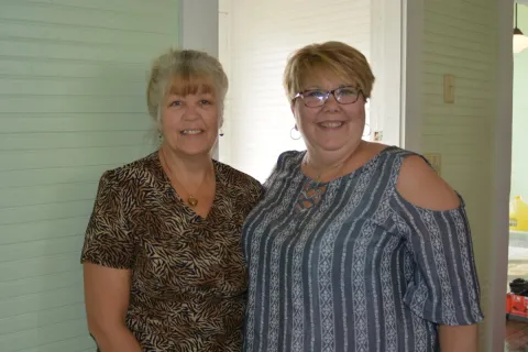 Sherry Medina of Sharps Chapel Book Station and Chantay Collins of Maynardville Public Library attend the grand re-opening of Oak Grove School, which will house Sharps Chapel Book Station.