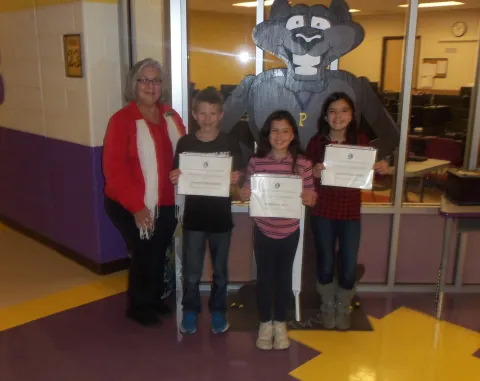 Pictured left to right: Sandra Greene of Union County Soil Conservation District presenting awards to Benjamin Brock, Hadley Berry, and Valentina Moshe. 