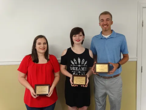 Samantha Sutton, Destini Thomas, Seth Beeler with plaques.