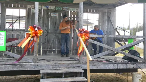 Contestant Eric Nafziger fiddles his best tune with Ken Nafziger to try to win the 2019 Fiddle Contest during the Union County Heritage Festival at Wilson Park.