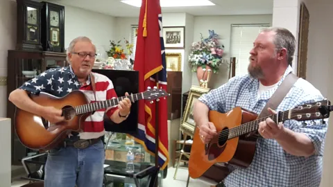 Two men singingcountry music in a museum