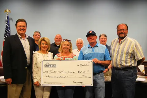 Phil Ruth presents a check for the Luttrell Music Festival to organizer Mayme Taylor