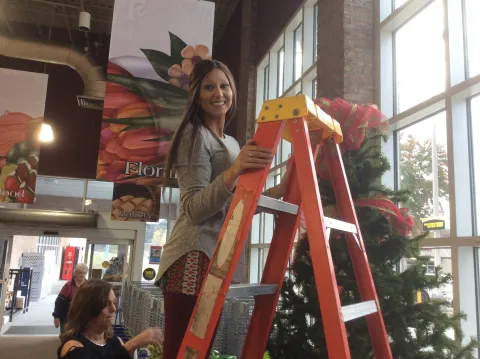 Chief Elf Brooke Simpson and Gina Buckner putting a tree up at Food City.  Brooke is the brains amongst the paper work to keep things organized.