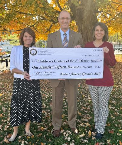  District Attorney General Jared Effler presenting this year’s check to staff from the 8th District Children’s Centers (left – Executive Director Tracie Davis and right – CFO and COO Patty Swain).