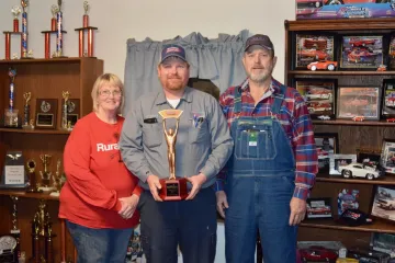 Connie, Buddy and Floyd Archer show a recent drag racing trophy.