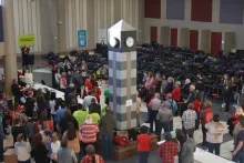 Volunteers with Under the Tree gather for prayer before the Christmas gift distribution.