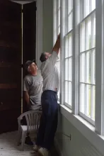 Preservation Union County volunteers Stan Bullen and Joe Rogers work on the windows at Oak Grove School in Sharps Chapel.