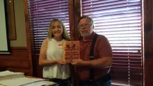 Girl receiving a plaque for an academic scholarship